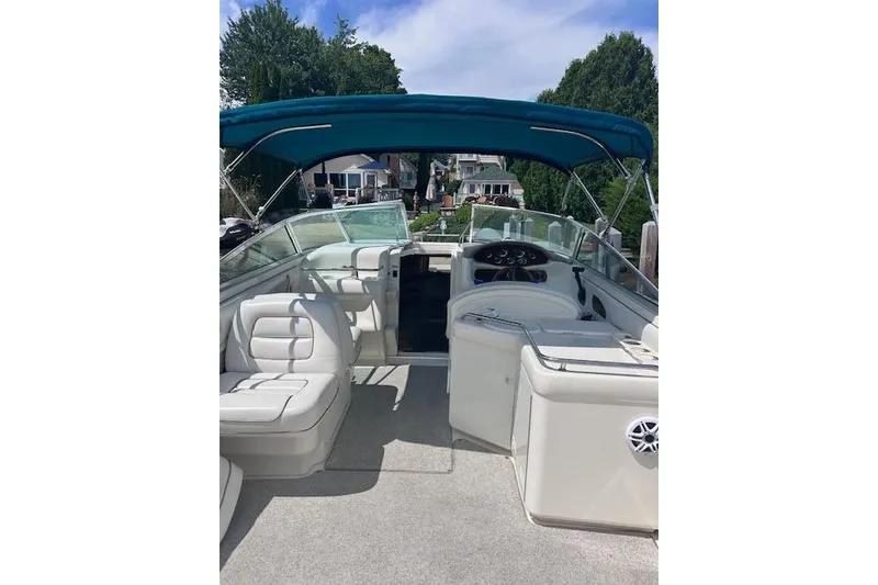 Slide: The Image of 1998 Sea Ray 280 Cuddy Cabin boat interior with blue canopy and white seating. - 2
