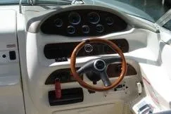Slide: The Image of 1998 Sea Ray 280 Cuddy Cabin dashboard with wooden steering wheel and instrument panel. - 4