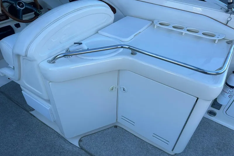 Slide: The Image of 1998 Sea Ray 280 Cuddy Cabin interior with helm and storage area. - 8