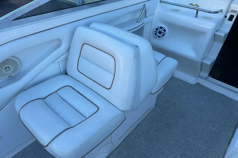 Slide: The Image of 1998 Sea Ray 280 Cuddy Cabin interior with white cushioned seating and speaker. - 9