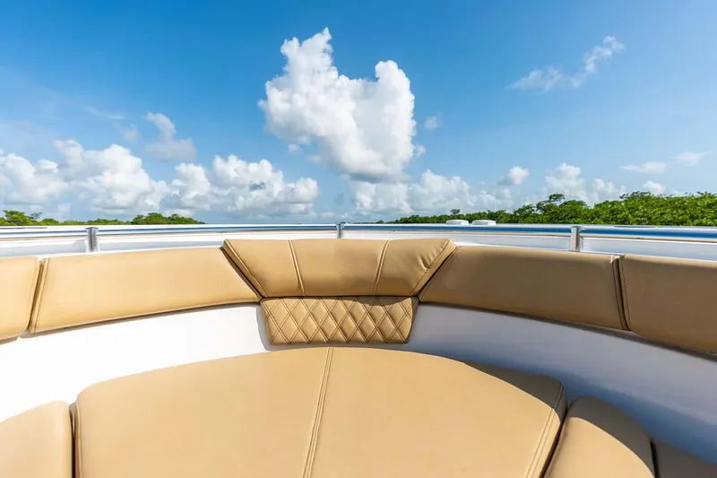 Slide: The Image of Manufacturer Provided Image: 2025 Sportsman Heritage 261 Center Console boat with tan seating under a blue sky. - 10
