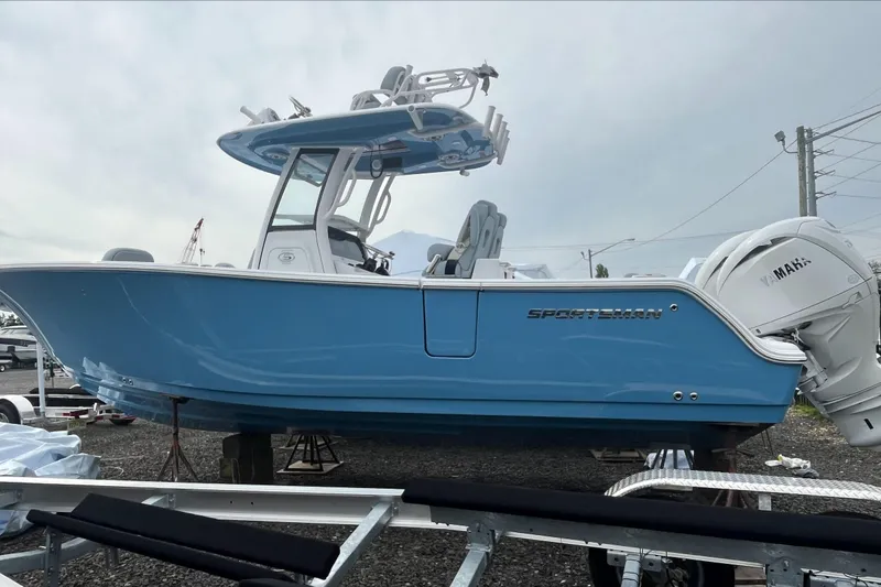 The Image of 2026 Sportsman Open 262 Center Console boat in light blue, displayed on a trailer. - 0