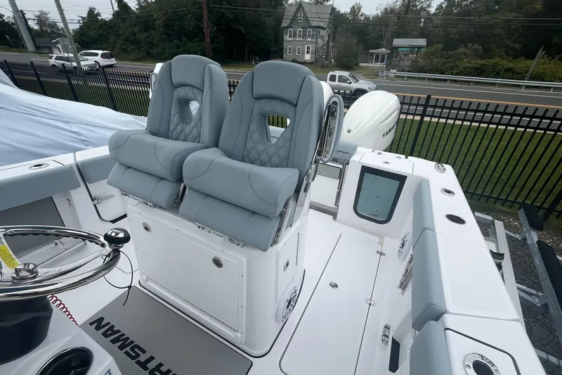 Slide: The Image of 2026 Sportsman Open 262 Center Console boat with dual seats and Yamaha engine. - 1