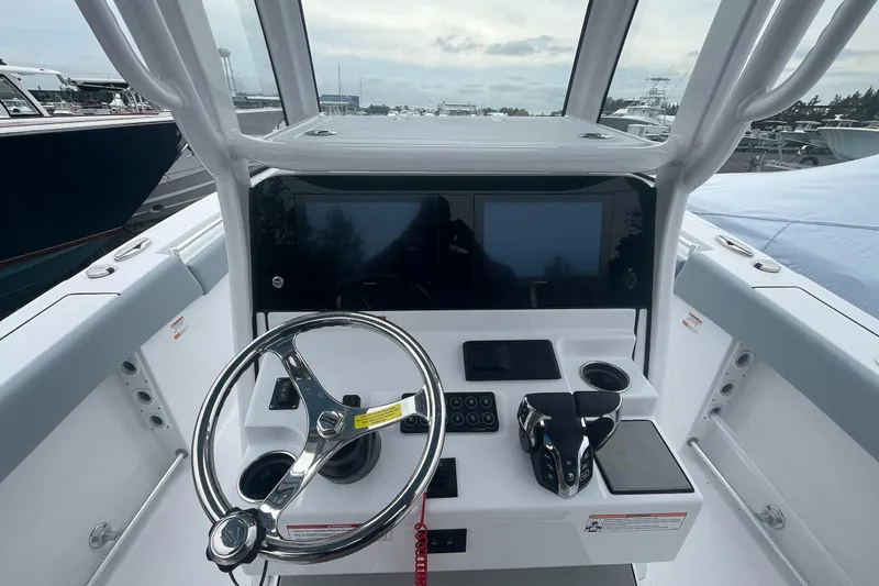Slide: The Image of 2026 Sportsman Open 262 Center Console boat dashboard with steering wheel and controls. - 2