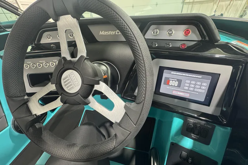 Slide: The Image of 2026 MasterCraft NXT22 boat dashboard with steering wheel and digital display. - 20