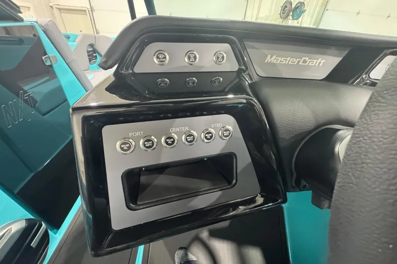 Slide: The Image of 2026 MasterCraft NXT22 dashboard with control buttons and branding. - 7