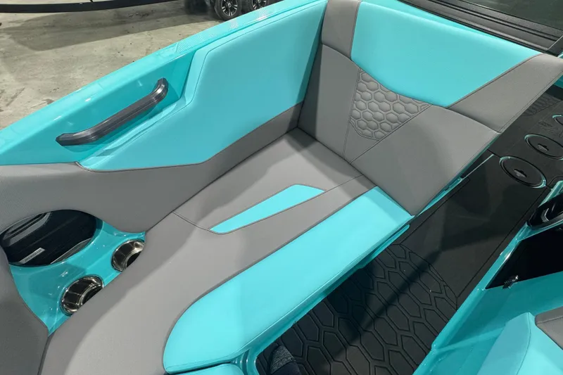 Slide: The Image of 2026 MasterCraft NXT22 boat interior with turquoise and gray seating, cup holders, and modern design. - 8