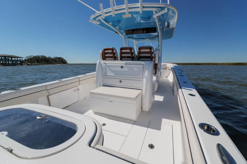 Slide: The Image of 2024 Valhalla Boatworks V-33 on water, showcasing sleek deck and seating arrangement. - 16