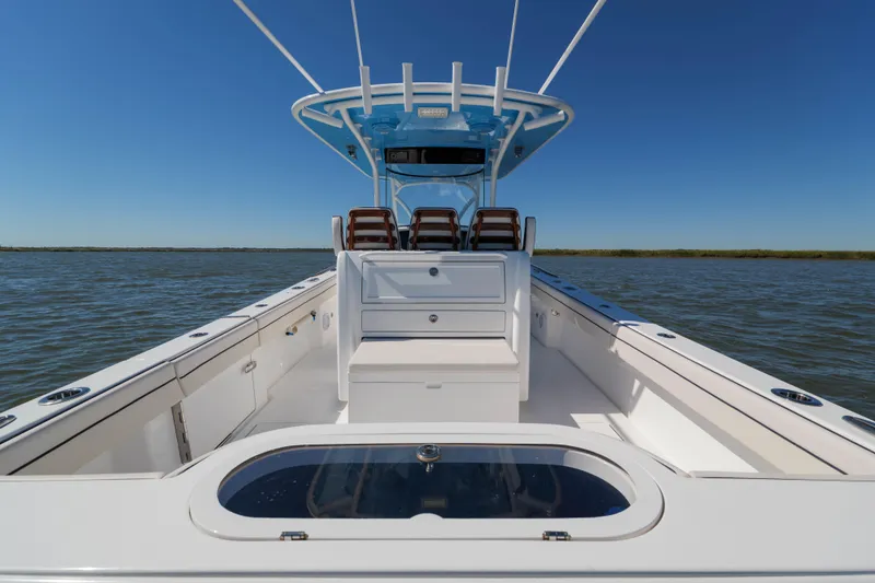 Slide: The Image of 2024 Valhalla Boatworks V-33 on water, showcasing sleek design and spacious deck. - 17