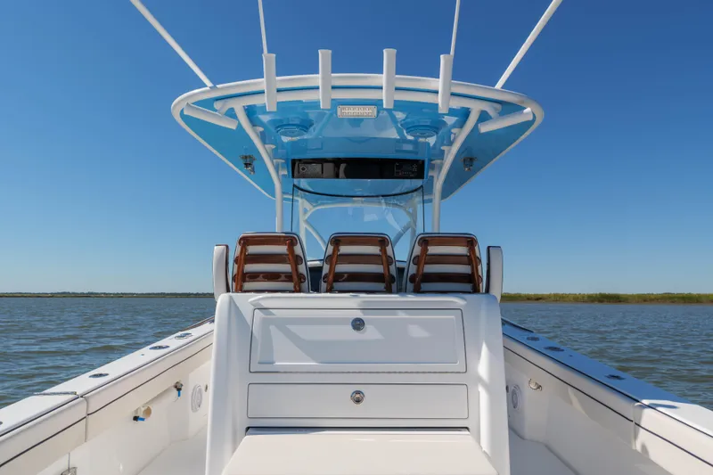 Slide: The Image of 2024 Valhalla Boatworks V-33 center console on calm water, showcasing sleek design. - 18