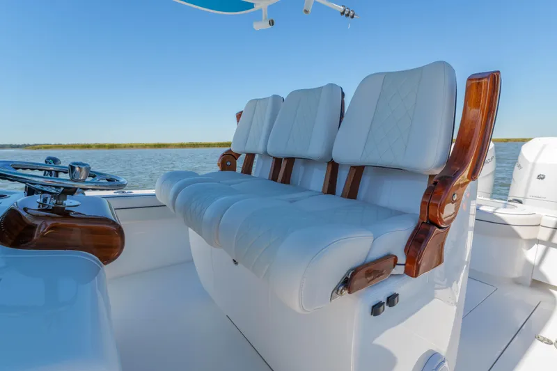 Slide: The Image of 2024 Valhalla Boatworks V-33 interior with luxurious white seating and wooden accents. - 21