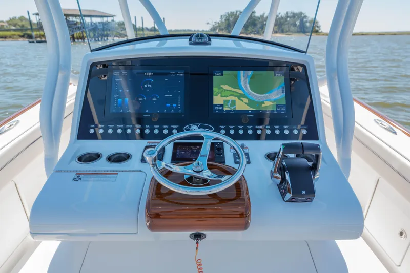Slide: The Image of 2024 Valhalla Boatworks V-33 helm with advanced navigation displays and controls. - 24
