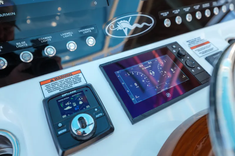 Slide: The Image of 2024 Valhalla Boatworks V-33 dashboard with control panel and digital display. - 27
