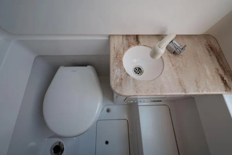 Slide: The Image of 2024 Valhalla V-33 boat bathroom with toilet and marble sink countertop. - 35