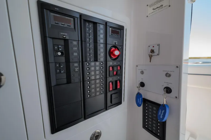 Slide: The Image of 2024 Valhalla Boatworks V-33 control panel with switches and keys. - 36
