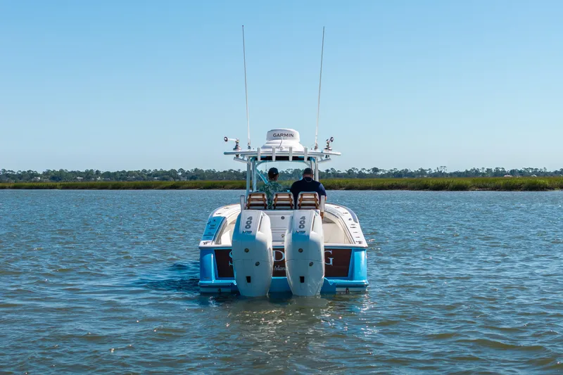 Slide: The Image of 2024 Valhalla Boatworks V-33 cruising on calm waters, rear view. - 40