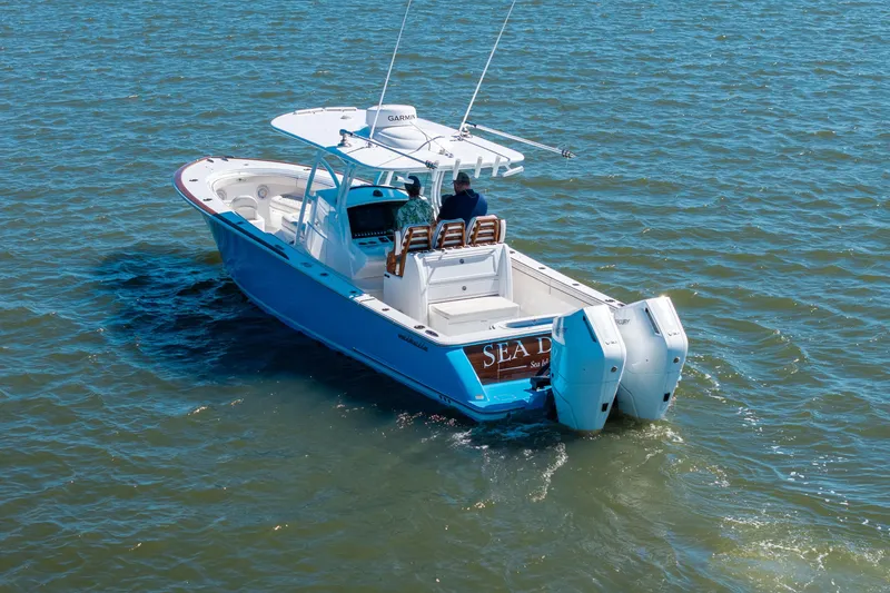 Slide: The Image of 2024 Valhalla Boatworks V-33 cruising on open water, featuring dual outboard engines. - 41