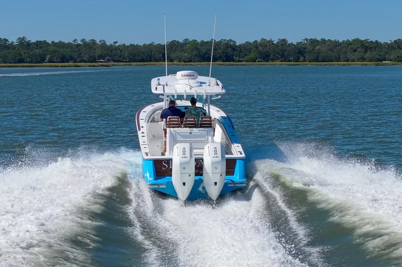 Slide: The Image of 2024 Valhalla Boatworks V-33 cruising on a serene lake with twin engines. - 46