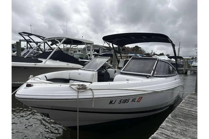 The Image of 2018 Regal 21 OBX boat docked at marina under cloudy skies. - 1