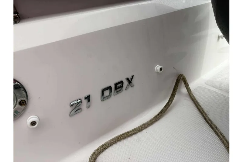 Slide: The Image of 2018 Regal 21 OBX boat model nameplate with rope detail. - 11