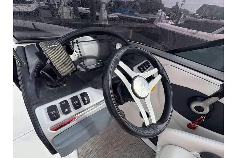 Slide: The Image of 2018 Regal 21 OBX boat dashboard with steering wheel and control panel. - 20