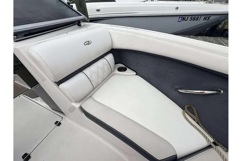 Slide: The Image of 2018 Regal 21 OBX boat interior with white seating and cup holder. - 21