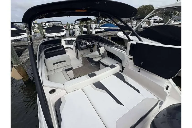 Slide: The Image of 2018 Regal 21 OBX boat interior with seating and helm, docked at marina. - 6