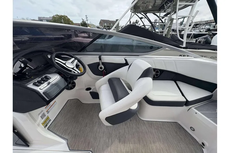 Slide: The Image of 2018 Regal 21 OBX boat interior with steering wheel and seating area. - 8