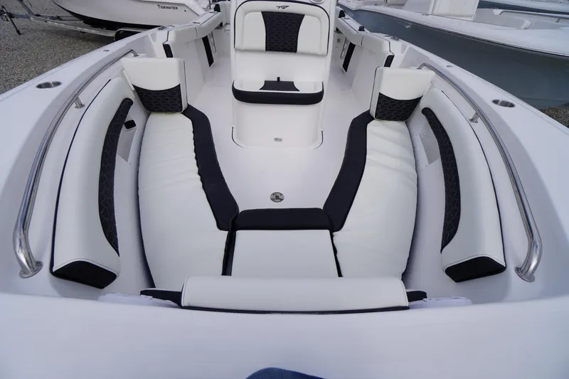 Slide: The Image of 2026 Tidewater 232 LXF boat interior with white and black cushioned seating. - 10