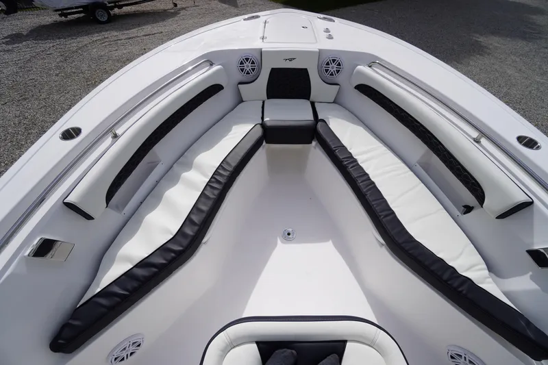 Slide: The Image of 2026 Tidewater 232 LXF boat interior with cushioned seating and speakers. - 11