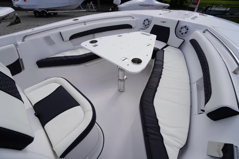 Slide: The Image of 2026 Tidewater 232 LXF boat interior with white and black seating and a central table. - 14