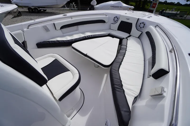 Slide: The Image of 2026 Tidewater 232 LXF boat interior with white and black cushioned seating. - 15