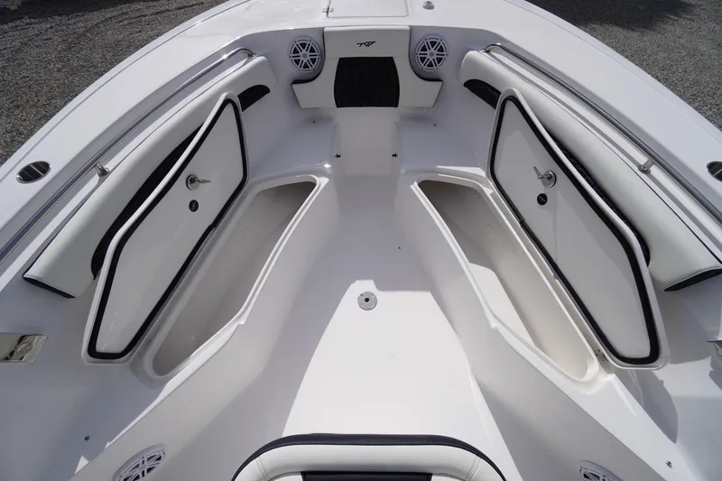 Slide: The Image of 2026 Tidewater 232 LXF boat interior with open storage compartments and speakers. - 18