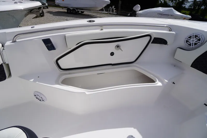 Slide: The Image of 2026 Tidewater 232 LXF boat interior with open storage compartment and speakers. - 19