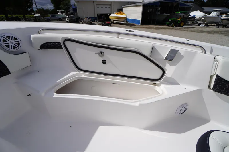 Slide: The Image of 2026 Tidewater 232 LXF boat interior with open storage compartment and speaker. - 20