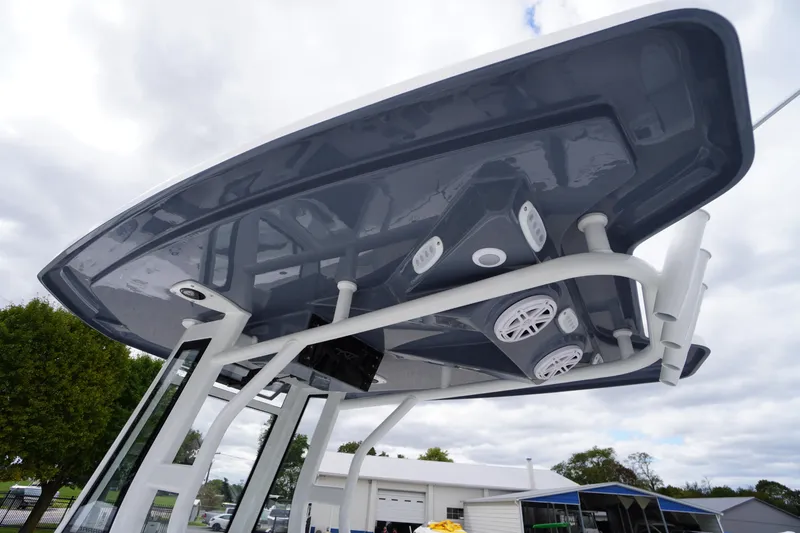 Slide: The Image of 2026 Tidewater 232 LXF boat with sleek overhead design and integrated speakers. - 24