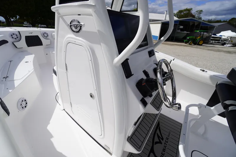 Slide: The Image of 2026 Tidewater 232 LXF boat interior with steering wheel and control panel. - 26