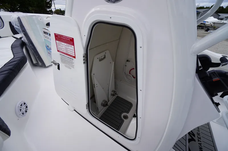 Slide: The Image of 2026 Tidewater 232 LXF boat interior storage compartment with open door. - 27