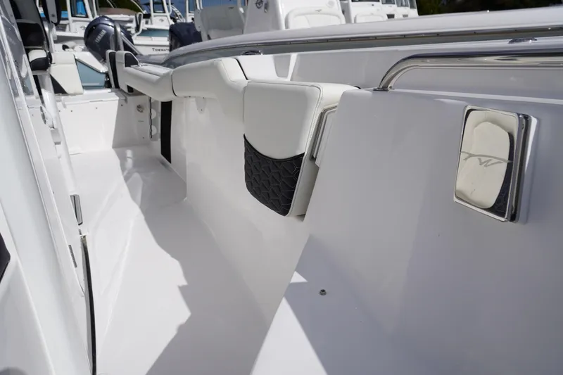 Slide: The Image of 2026 Tidewater 232 LXF boat interior with sleek white seating and modern design. - 31