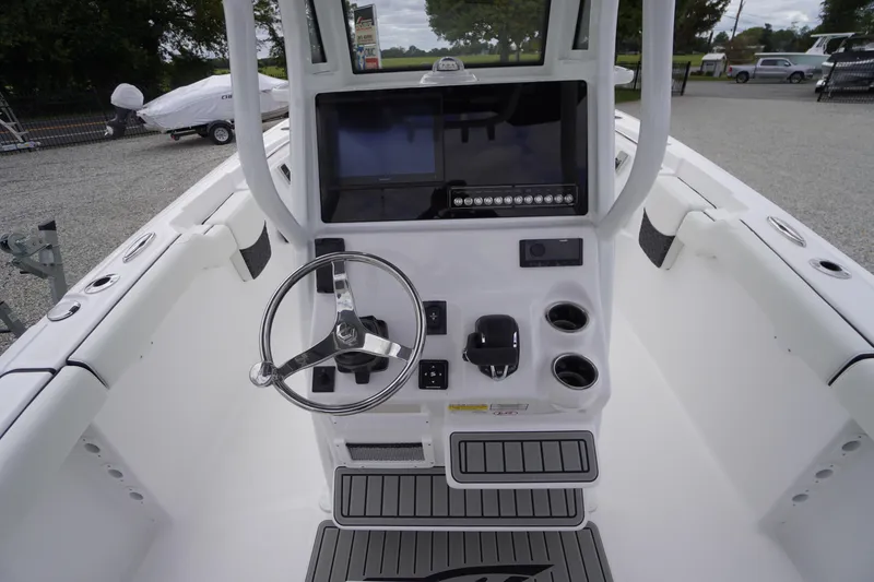 Slide: The Image of 2026 Tidewater 232 LXF boat console with steering wheel and modern controls. - 35