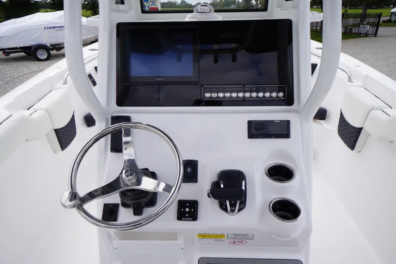 Slide: The Image of 2026 Tidewater 232 LXF boat console with steering wheel, touchscreen, and controls. - 36