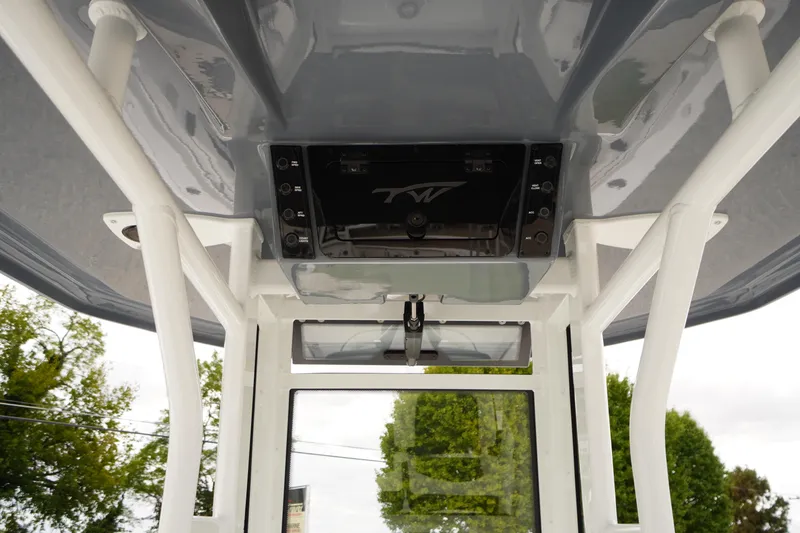 Slide: The Image of 2026 Tidewater 232 LXF boat console with overhead electronics and sturdy framework. - 37