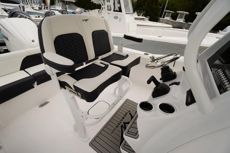 Slide: The Image of 2026 Tidewater 232 LXF boat interior with dual seats and steering console. - 39