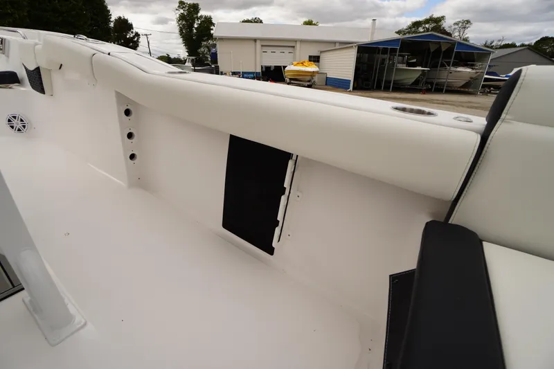 Slide: The Image of 2026 Tidewater 232 LXF boat interior, featuring sleek white seating and storage compartments. - 41