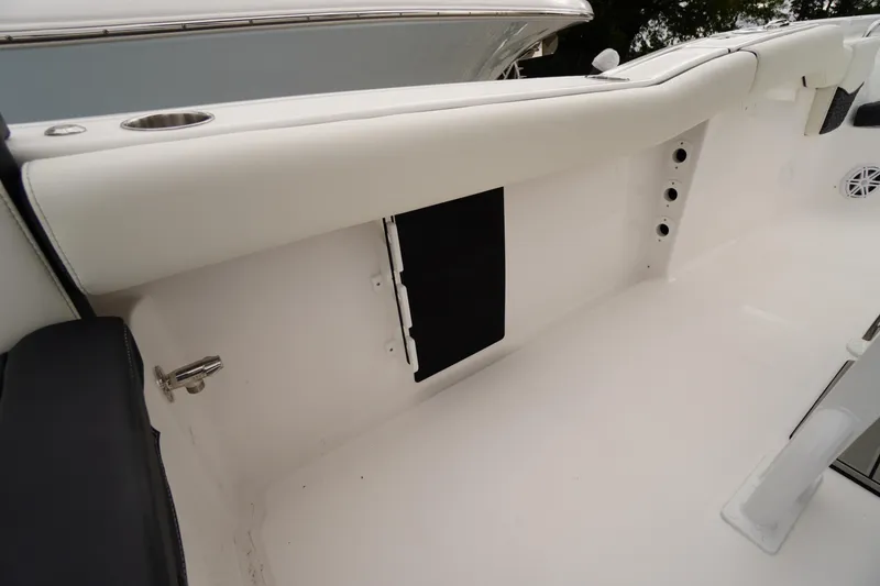 Slide: The Image of Interior view of 2026 Tidewater 232 LXF boat, featuring sleek white seating and storage. - 42