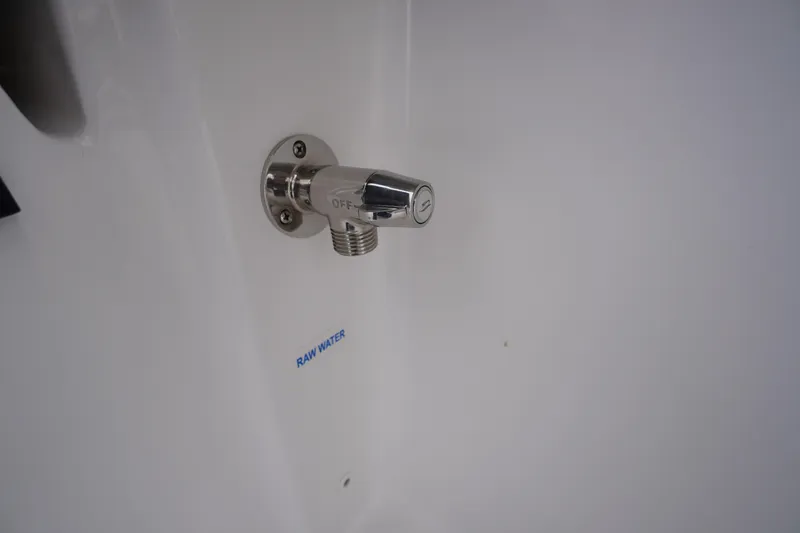 Slide: The Image of Chrome water outlet labeled "Raw Water" on 2026 Tidewater 232 LXF boat. - 43