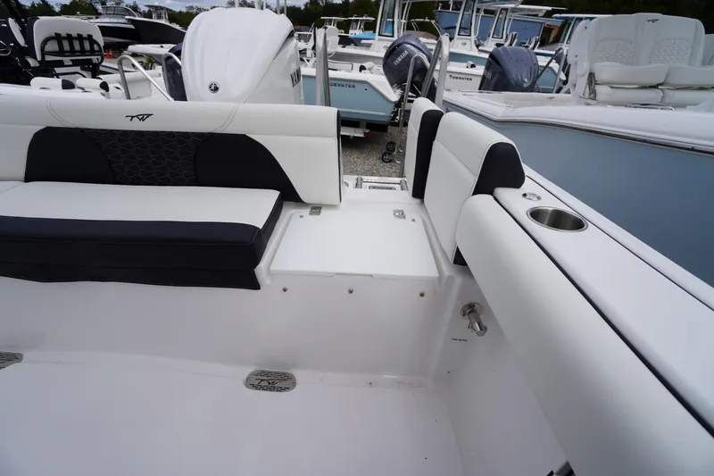 Slide: The Image of 2026 Tidewater 232 LXF boat interior with seating and cup holder, showcasing modern design. - 46