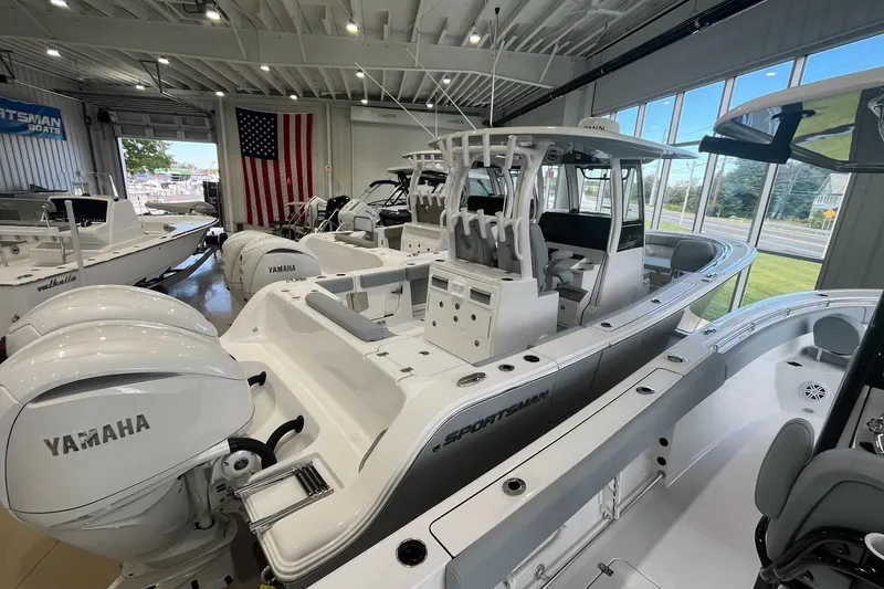 The Image of 2026 Sportsman Open 282 Center Console boat in showroom with Yamaha engines. - 0