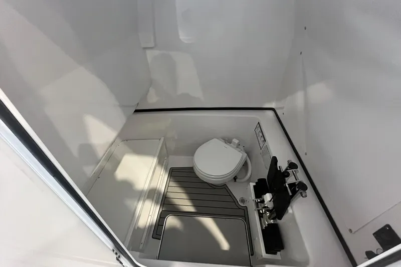 Slide: The Image of Interior of 2026 Sportsman Open 282 Center Console boat with compact marine toilet. - 5