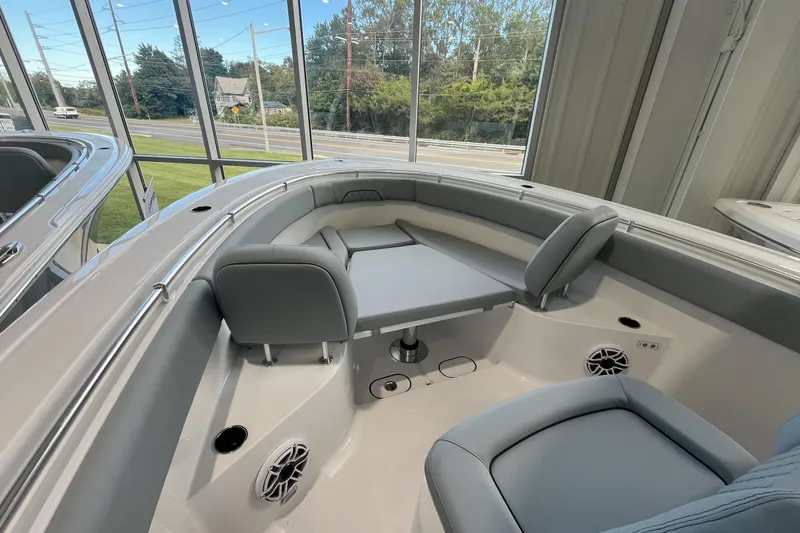 Slide: The Image of 2026 Sportsman Open 282 Center Console boat interior with seating and table. - 8